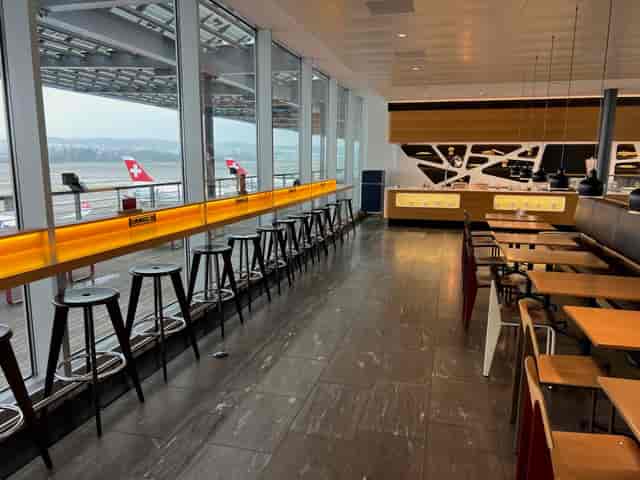 Zurich Development Center airport lounge with tarmac views for business events and productivity.
