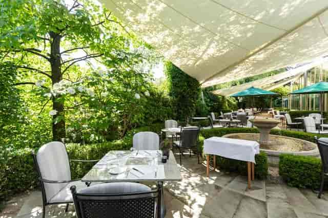 Outdoor restaurant venue with water feature for upscale brunch and corporate luncheon events.