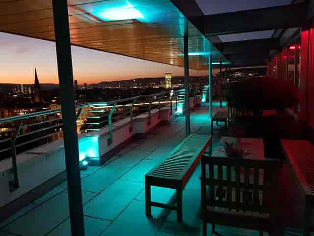 Rooftop terrace at The Roof with city skyline, ideal for networking events and VIP cocktail hours.