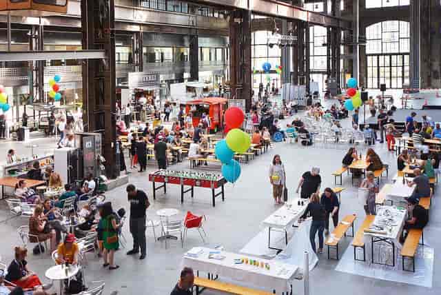 Industrial event hall in Puls 5 Zurich, open-plan venue for community gatherings and workshops.