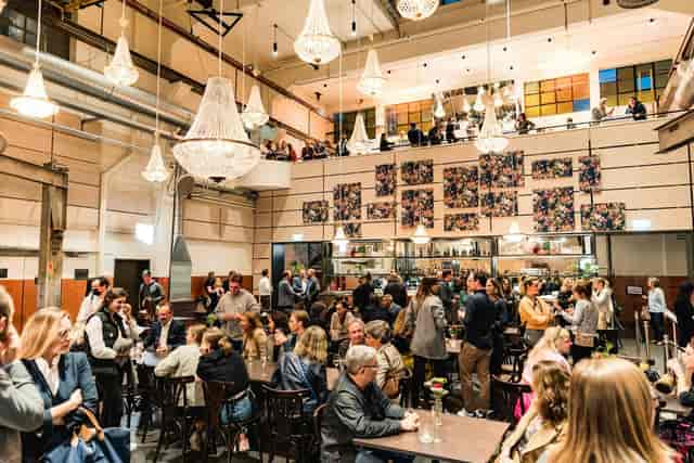 MAAG Halle industrial venue with crystal chandeliers for sophisticated networking and corporate events.