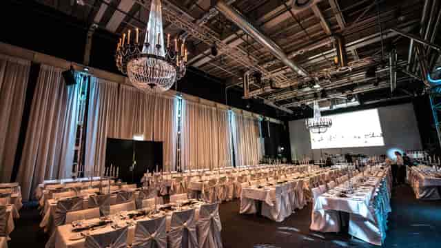 Elegant StageOne Event Hall with chandeliers and drapery, perfect for corporate galas or weddings.