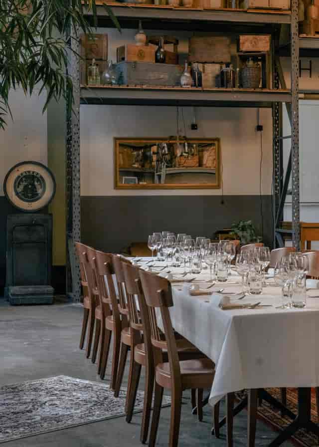 1928 Chicago industrial-chic event venue with white linens for corporate dinner or board lunch.