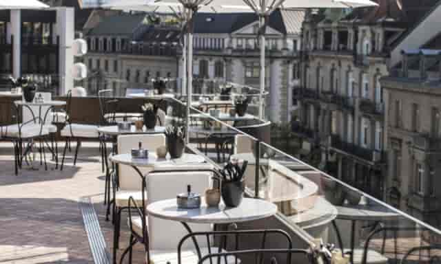 Upscale rooftop terrace for networking receptions and corporate events with city views.