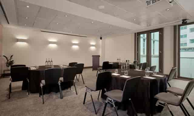Millennium Suite at Park Plaza: elegant meeting room with round tables for professional events.