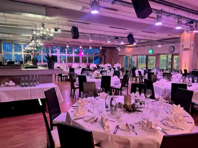 Industrial gala event space at eins0eins with mood lighting, ideal for formal dinner venues.