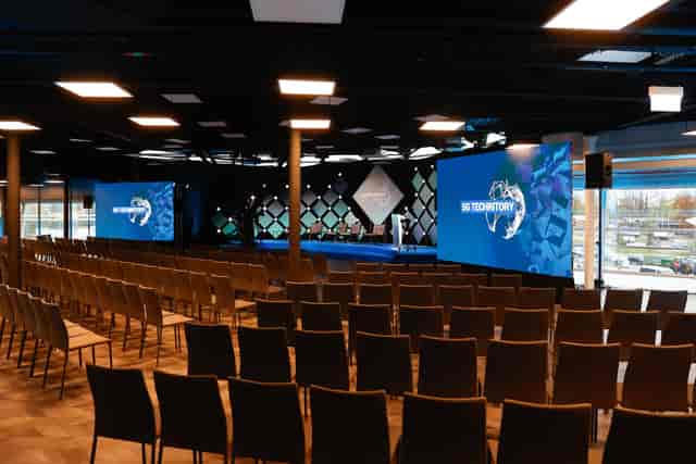Atta Centre theater-style conference room with dual screens for corporate event planning.