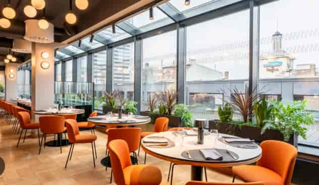Modern Aston Hotel Riga conference room with orange seating for business luncheons and networking.