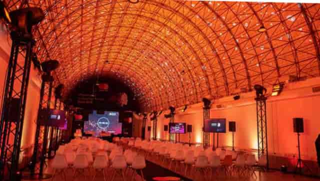 Contemporary event space with arched ceiling, ideal for corporate gatherings and conferences.