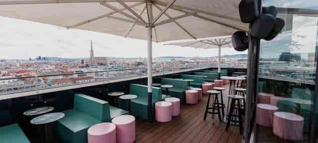 Rooftop networking mixer at JUWEL Vienna with skyline views and modular seating.