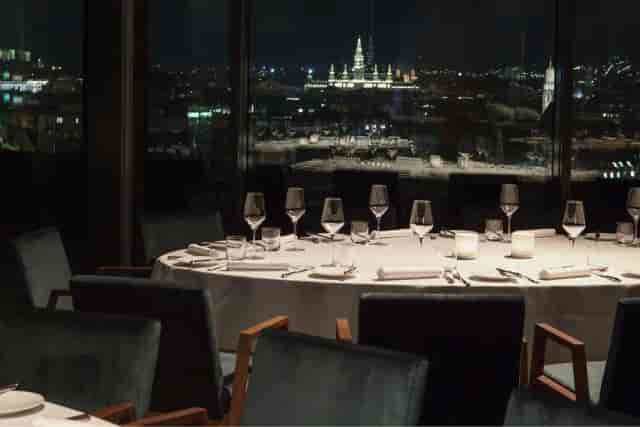 Elegant gala dinner at JUWEL featuring floor-to-ceiling windows for executive networking events.