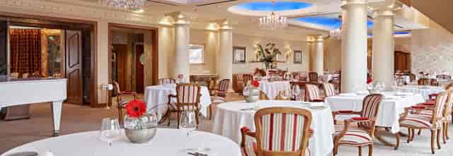 Elegant 1870 restaurant terrace lounge with columns for upscale private dinners and events.