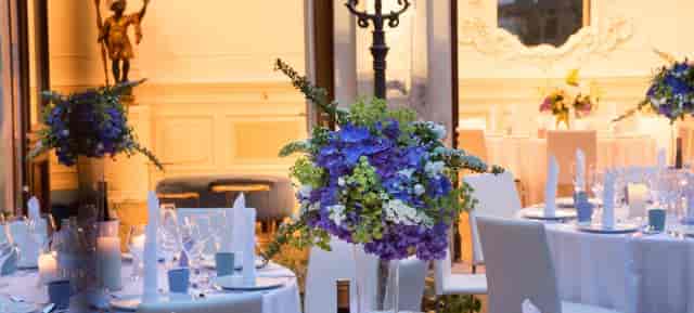 Upscale ballroom event at VIENNABallhaus with elevated floral centerpieces for gala or wedding.