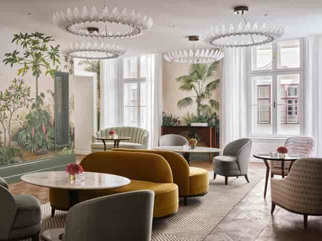 Salon Aurelie boutique meeting space with botanical murals for VIP events and networking.