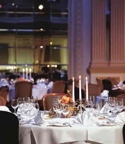 Elegant ballroom gala setup with tapered candelabras for corporate banquets or formal receptions.
