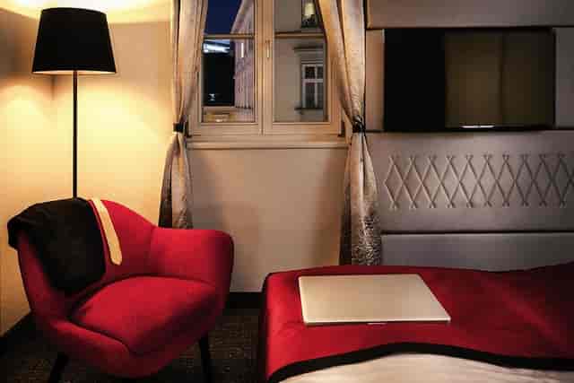 Mercure Boutique Hotel Vienna suite: laptop and suit, perfect for business travel and events.