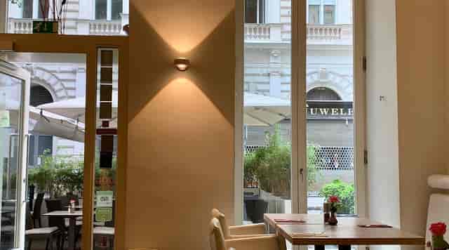 Modern restaurant event space with architectural lighting for networking breakfasts and meetings.