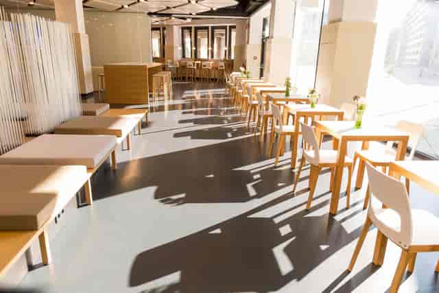 Business lounge with cafe and bench seating at Austria Center Vienna for conferences and networking.