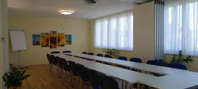 U-shape boardroom at d'FarbeSPACE with fluorescent lighting for budget meetings and conferences.