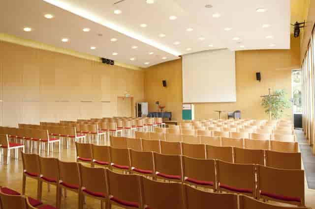 Theater-style auditorium at Kardinal König Haus for corporate presentations and academic lectures.