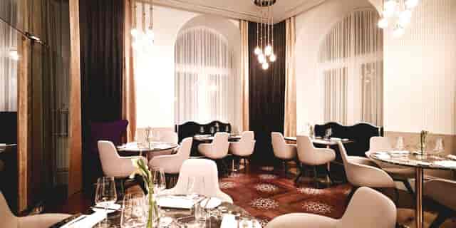 Executive dining room with plush seating for VIP corporate events and intimate meetings.