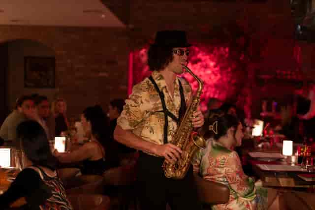 Live saxophone performance at Bocconcino Mayfair for experiential dining event atmosphere.