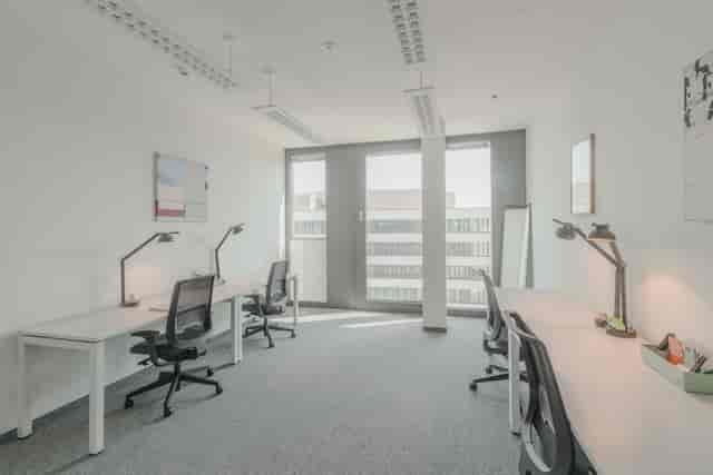 Minimalist breakout meeting room for corporate collaboration and professional coworking.