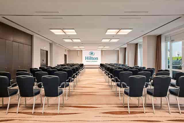 Theater-style Hilton Vienna conference room with natural light for corporate seminars and meetings.