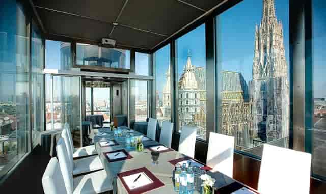 Luxury boardroom at DO & CO Hotel Vienna with iconic city view for executive retreats and meetings.