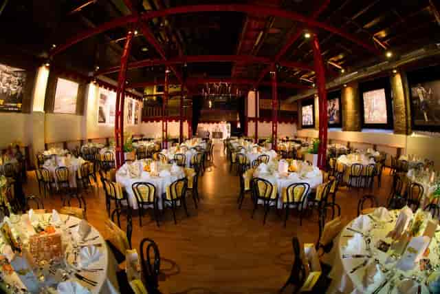 Industrial-chic Palladion XXI arena with exposed beams, perfect for galas and social events.