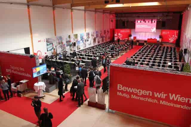 Spectacula plenary room with branded signage, classroom setup for corporate event and conference.