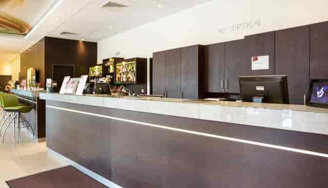 Hotel Doppio reception desk for conference guest check-in and event registration.