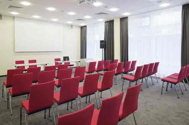 Theater-style breakout room at Hotel Doppio with natural light for corporate meetings and seminars.