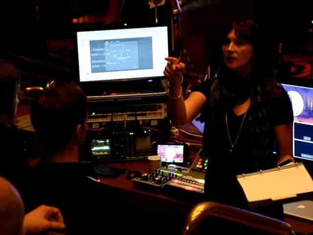 Production lead conducting tech briefing for event production at Encore Vienna.