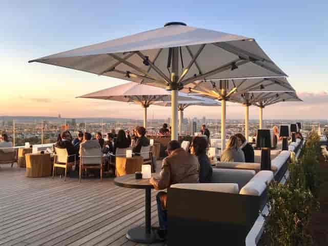 Rooftop networking reception at Aurora with lounge seating and premium skyline views.