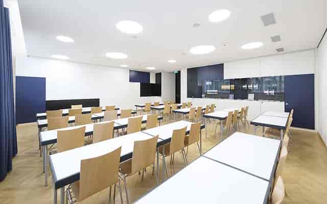 Modern UNIQA conference room set up for corporate training workshops and business seminars.