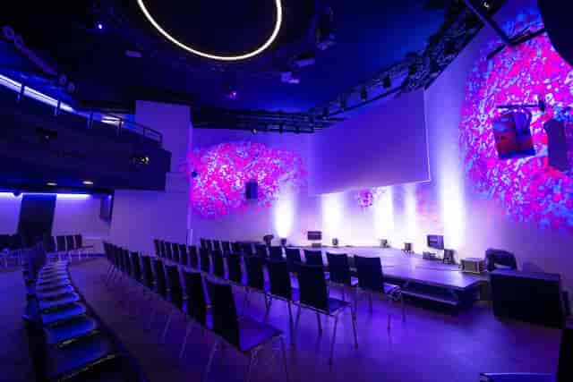 Modern lobby auditorium with stage for corporate product launches and keynote events.