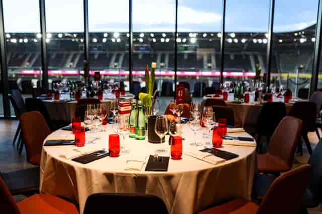 VIP CUBE hospitality suite with red accents, premium stadium view for corporate sports events.