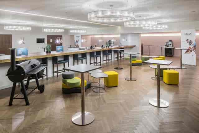 Modern executive boardroom with high-top tables for corporate networking and business events.