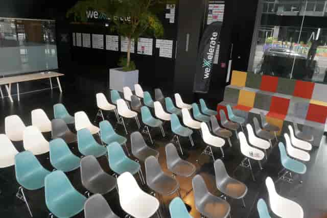 Modern weXelerate auditorium with theater seating for corporate events and conferences.