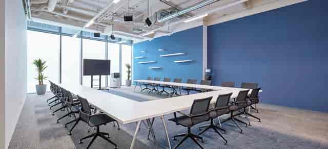 Modern U-shaped boardroom at weXelerate for corporate workshops and professional meetings.
