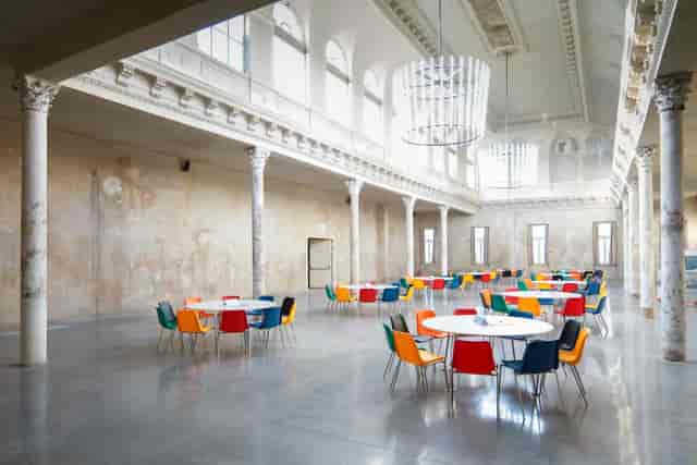 Industrial event space at REAKTOR with high ceilings for weddings and corporate conferences.