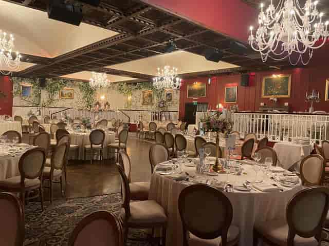 Cabra Castle ballroom with ornate chandeliers set for a formal wedding banquet.