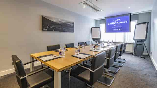 Newbridge Suite boardroom set for 10 with AV for corporate meetings and business conferences.