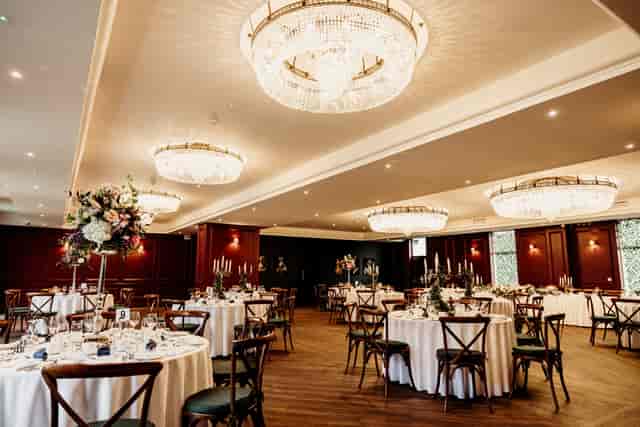 Grand ballroom at The Abbey with crystal chandeliers, ideal for luxury weddings and gala events.