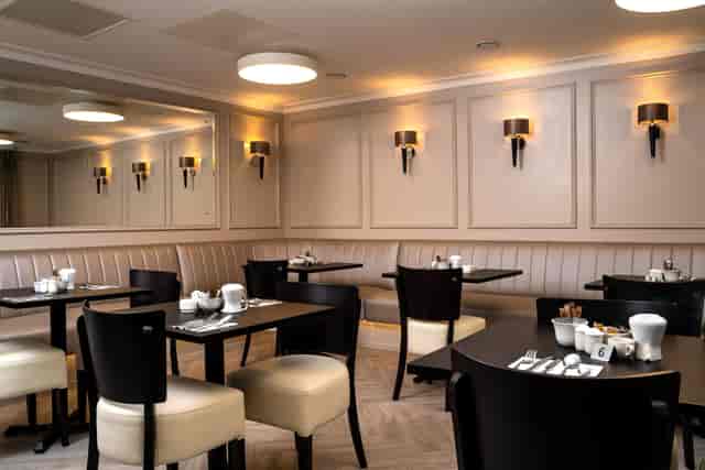 Formal dining room with banquette seating, ideal for corporate events and private catering.