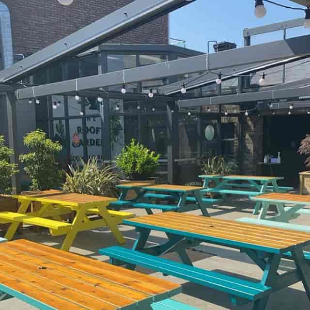 Outdoor picnic seating at ONE Sky Garden for corporate networking and team-building events.