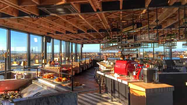 Sophisticated rooftop bar for corporate cocktail receptions and networking events with city views.