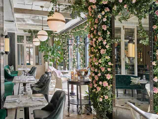 High-end garden dining room with floral decor for bridal showers and boutique corporate events.