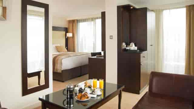 Modern hotel suite with workspace for business travel and corporate event hosting.